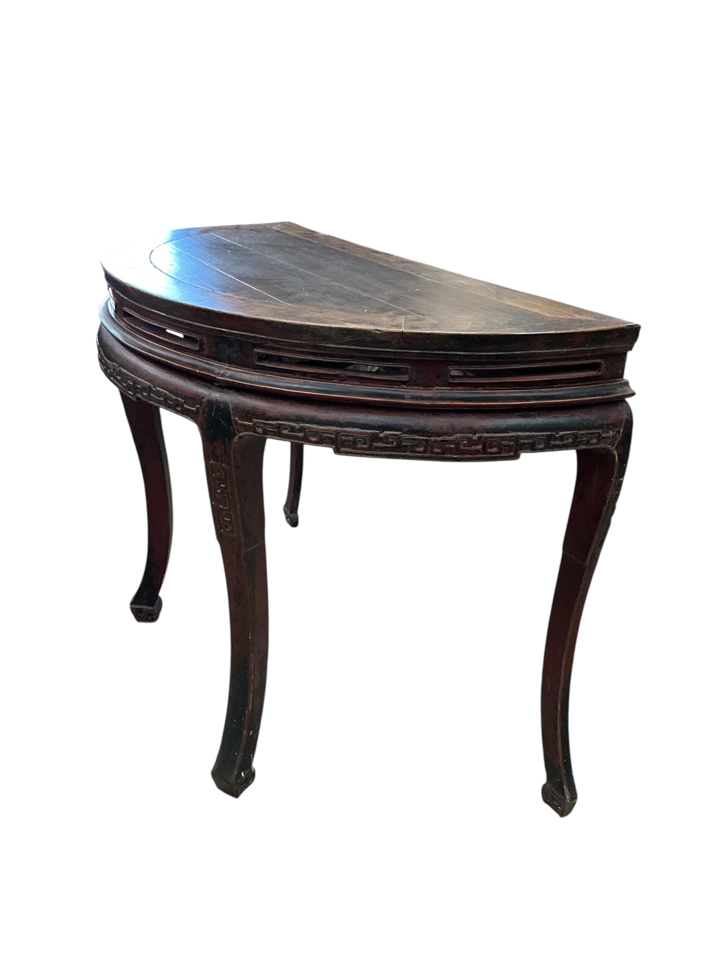 A pair of Chinese part lacquered demi lune console tables, width 124cm, depth 63cm, height 90cm